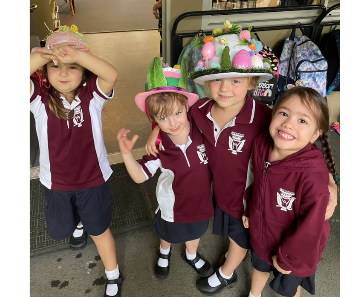 Four female students posing with their Easter Hats on.