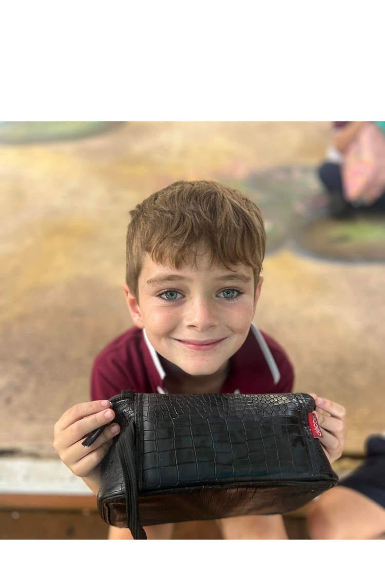 A close up of the smiling face of a young male student.